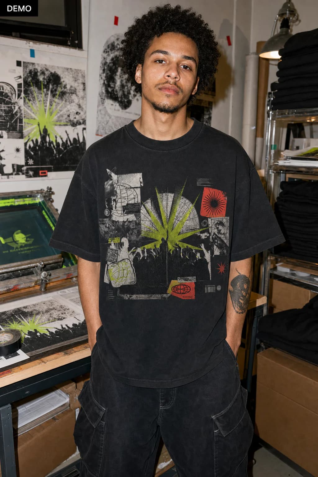AI demo persona Sam in a print studio wearing the matching crowd, acid burst, and poster-collage graphic